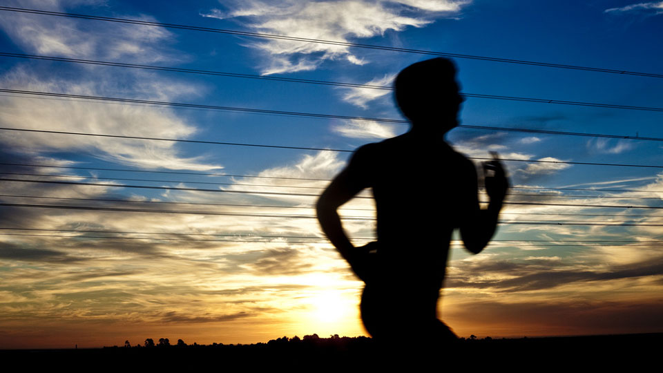 Image of man running in the sunset