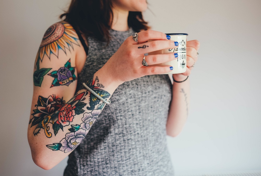 Tattood woman with tea cup